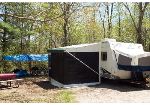 Expandable RV tent on a camper in the woods